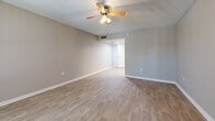 Located at 1699 68th St N in Saint Petersburg, Florida, this efficiently designed single-floor unit offers a well-planned layout that maximizes every inch of available space. Light-toned luxury vinyl plank flooring runs consistently throughout, lending a clean, cohesive look to the interior.

The kitchen is thoughtfully appointed with crisp white cabinetry, granite-style countertops, and stainless steel appliances, including a full-size refrigerator, electric range, built-in microwave, and dishwasher. A undermount sink with a modern faucet completes the functional workspace.

The open living area benefits from natural light streaming through a large window, and a ceiling fan with integrated lighting provides both comfort and illumination. The textured ceiling adds a classic touch, while neutral warm-gray walls create a versatile backdrop throughout the space.

Two closets offer practical storage solutions, one of which features built-in shelving for added organization. The bathroom is finished with matching granite-topped vanity cabinetry, a white subway tile shower surround, wood-look flooring, and clean white walls that keep the space feeling bright and fresh.

Overall, this unit presents a well-maintained, move-in ready space with consistent, updated finishes in a convenient Saint Petersburg location.
