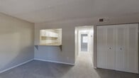 Located at 3248 Chamblee Dunwoody Rd in Chamblee, GA, this single-floor, 3-bedroom, 1-bathroom unit offers a practical and functional layout. The open living, dining, and kitchen area forms the heart of the home, anchored by a pass-through kitchen counter with a breakfast bar overhang. The kitchen is equipped with white cabinetry, laminate countertops, a stainless steel sink, electric range, and a full-size refrigerator, with a separate pantry providing additional storage. Textured ceilings and neutral gray walls carry throughout the unit, lending a clean, consistent aesthetic. Carpet flooring flows through the living space and all three bedrooms. The spacious primary bedroom features dual louvered closets, a built-in vanity with sink, a ceiling fan, and a window allowing natural light. The two additional bedrooms are also carpeted, each with louvered closet doors and windows with blinds. Ceiling fans are present in the bedrooms, enhancing comfort. The shared bathroom includes a full tub-shower combo with white tile surround. Three closets throughout the unit offer ample storage for residents.