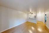Located at 6351 Country Club Dr in Rohnert Park, CA, this one-bedroom, one-bathroom unit offers a well-organized single-floor layout designed for comfortable everyday living. The entrance opens into a bright hallway with light hardwood-style flooring that flows throughout the main living areas. The combined kitchen and living room serves as the heart of the unit, featuring an open, airy feel enhanced by a ceiling fan and a sliding glass door that leads to a private balcony overlooking the surrounding neighborhood. The kitchen is efficiently designed with white cabinetry, light countertops, a stainless steel gas range, a stainless steel refrigerator, and a built-in range hood — all positioned around a peninsula that separates the kitchen from the living area. A wall-mounted heater unit provides climate control in the living space. The bedroom is carpeted for comfort and features mirrored sliding closet doors that add depth to the room, along with additional closet storage accessible throughout the unit. The bathroom is clean and functional, equipped with a full tub-shower combination, a vanity with sink, and chrome fixtures. A dedicated hallway connects all areas of the unit, providing smooth circulation and privacy between the living and sleeping spaces.