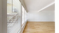 Located at 390 N Madison Ave in Pasadena, CA, this one-bedroom, one-bathroom unit offers a well-organized single-floor layout designed to maximize every square foot. Light-toned hardwood flooring runs throughout the entire space, creating a cohesive and clean aesthetic that enhances the sense of openness.

The living room is a standout feature, boasting a bank of large windows fitted with blinds that invite abundant natural light while maintaining privacy. The bright, white walls amplify this effect, giving the space an airy and welcoming atmosphere.

The kitchen is efficiently laid out with white cabinetry, granite-style countertops, and stainless steel appliances including a range and refrigerator. A double-basin sink anchors the workspace, while open upper shelving adds a practical, accessible storage option.

The bedroom is a cozy, well-defined space with windows fitted with blinds and a wall-mounted air conditioning unit, ensuring year-round comfort. The clean white walls keep the room feeling fresh and adaptable to any style.

The bathroom features a classic black-and-white octagonal tile floor that adds a timeless, distinctive character to the room. A full tub-shower combo, toilet, and vanity with granite-style countertop complete this functional space. A small window provides natural light and ventilation. Overall, the unit presents a clean, modern, and move-in-ready aesthetic.