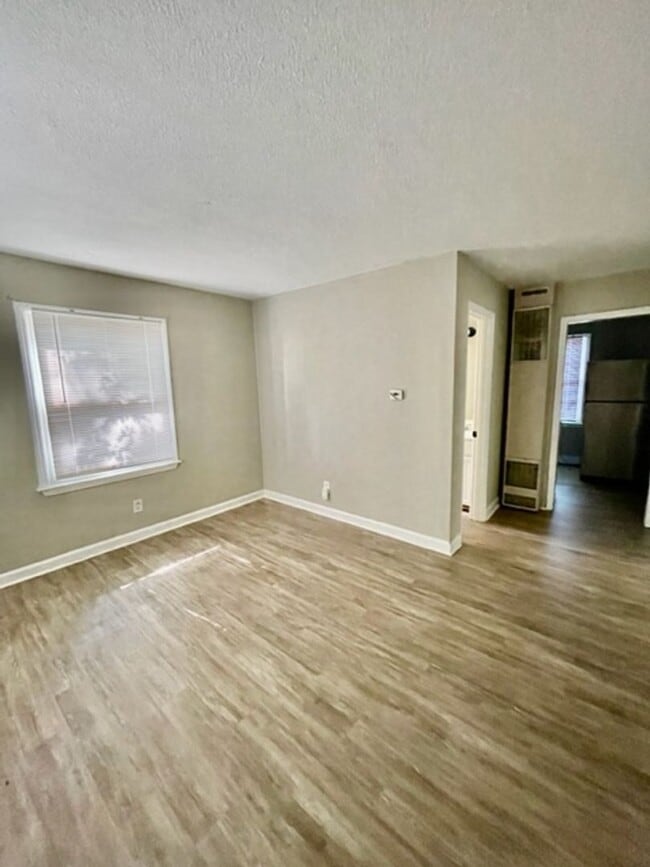 Building Photo - This cozy 2 bed 1 bath cottage style brick home is located on a corner lot of E 17th St and N McD...