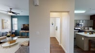 This two-floor residence offers a thoughtfully designed layout that balances functionality and comfort throughout. The kitchen is a standout feature, outfitted with sage-green cabinetry, white quartz countertops, stainless steel appliances including a gas range, microwave, and refrigerator, and a peninsula that provides additional prep and casual dining space. Wood-look flooring flows through the kitchen, hallways, and bathrooms, lending warmth and continuity to the home.

The living room is an inviting retreat, featuring plush carpet, a striking teal accent wall, and windows fitted with blinds that bring in natural light. The adjacent dining area is equally charming, with a classic chandelier overhead and direct access to a door leading outside.

The bedrooms are carpeted and fitted with sliding-door closets, offering ample storage. The full bathroom includes a tub-shower combination, a vanity with sage cabinetry, and rich hardwood-style flooring. A separate water closet provides added privacy and convenience. 

Completing the home is a dedicated in-unit laundry area with a full-size washer and dryer, along with overhead shelving for storage. Clean white walls, consistent trim work, and cohesive finishes throughout create a polished, move-in-ready atmosphere across both floors.