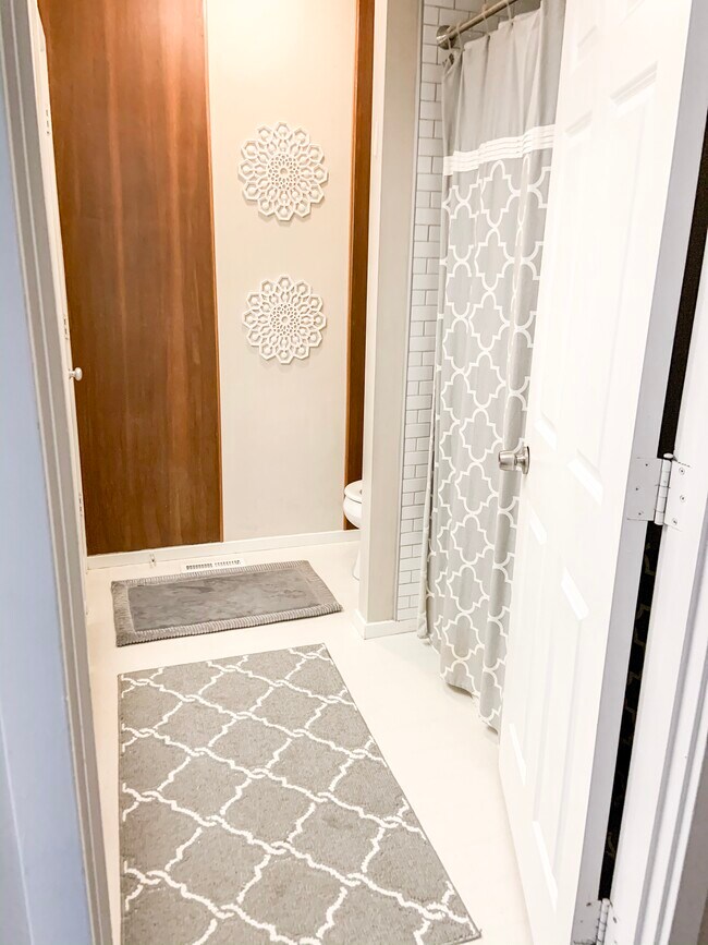 New toilet fixture and subway tile shower/tub wainscot - 6423 Colony Way