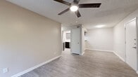 Located at 3601 Magic Dr in San Antonio, TX, this single-floor, 2-bedroom, 2-bathroom unit offers a well-organized layout with cohesive, updated finishes throughout. Wood-look luxury vinyl flooring flows through every room, complemented by neutral-toned walls, textured ceilings, and crisp white baseboards that create a clean, modern aesthetic.

The living room is a comfortable main gathering space featuring a ceiling fan with light, built-in shelving with cabinet storage below, and a sliding glass door that opens to a private patio with outdoor views. The adjacent dining area connects seamlessly to the kitchen, which is outfitted with gray shaker-style cabinetry, white subway tile backsplash, light countertops, a stainless steel range, and a dishwasher.

The primary bedroom offers a generous footprint, a ceiling fan, and direct access to its own bathroom, as well as a dedicated walk-in closet with built-in shelving and hanging rods. The second bedroom is well-sized, includes a ceiling fan, and benefits from a window that brings in natural light. Both bathrooms are finished with a single-sink vanity and a full tub-shower combination.

A hallway connects the bedrooms to the living areas, and the unit features four closets in total, providing abundant storage throughout.