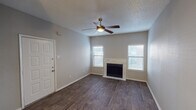 Located at 9180 Forest Ln in Dallas, TX, this single-floor unit offers a well-organized layout designed for comfortable everyday living. The living room serves as the heart of the space, featuring rich wood-style flooring, a ceiling fan with integrated lighting, a textured ceiling, and a marble-surround fireplace flanked by two windows that fill the room with natural light. Adjacent to the living area is a dining space highlighted by a pendant light fixture and wood-style flooring, with doorways leading to the kitchen and additional rooms. The galley-style kitchen is thoughtfully updated with white shaker cabinetry, granite-look countertops, a hexagonal tile backsplash, and stainless steel appliances including a refrigerator, dishwasher, microwave, and electric range. A closet at the end of the kitchen provides added storage convenience. The bedroom offers plush carpeting, a ceiling fixture, and a window with outdoor views, creating a calm retreat. The bathroom is outfitted with a white vanity, a tri-light fixture, a mirrored medicine cabinet, and wood-style flooring, offering a clean and functional design. Throughout the unit, neutral tones and consistent finishes contribute to a cohesive and inviting atmosphere.