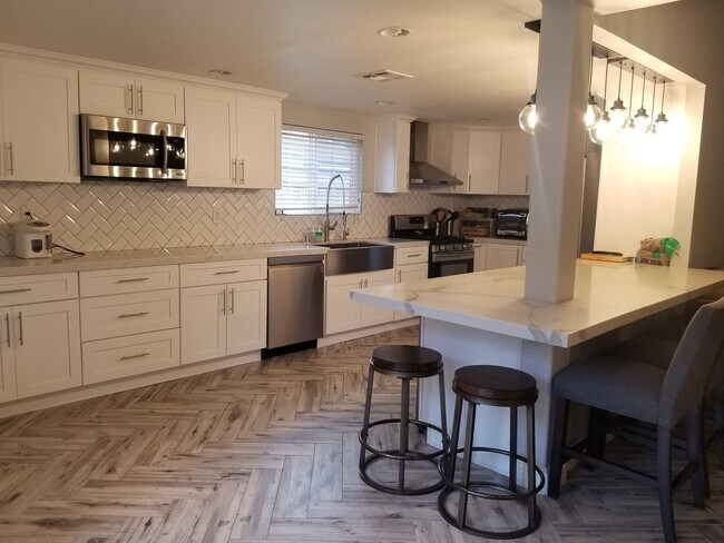 Kitchen with Quartz counters and stainless steel appliances - 688 Featherwood Dr