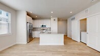 Located at 19939 Longenbaugh Rd in Houston, TX, this thoughtfully designed single-story home offers 2 bedrooms and 3 bathrooms within a well-utilized floor plan. The open-concept kitchen and living area serves as the heart of the home, featuring bright white cabinetry extending to the ceiling, a subway tile backsplash, stainless steel appliances including a refrigerator, range, and built-in microwave, and a central island with granite countertops and an integrated sink. Light wood-tone flooring flows consistently throughout the entire space, enhancing the clean, modern aesthetic. The spacious primary bedroom includes multiple windows for natural light, a ceiling fan, and access to a closet. The second bedroom is equally bright with natural light filtering through blinds and its own ceiling fan. The bathrooms are finished with granite-topped vanities and marble-style tile surrounds in the tub and shower areas. A dedicated laundry room houses a full-size washer and dryer. Recessed lighting and neutral wall tones throughout contribute to a cohesive, contemporary feel across the entire home.