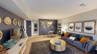 This well-appointed one-bedroom, one-bathroom residence in West Deptford, NJ offers a thoughtfully designed single-floor layout that maximizes comfort and functionality. The open-concept living and dining area serves as the heart of the home, featuring warm neutral tones accented by a bold navy feature wall adorned with a decorative world map — a striking focal point that adds character and depth. The living area transitions seamlessly to a sliding glass door, inviting natural light and outdoor views. A separate dining nook with pendant lighting completes the shared social space. The kitchen is equipped with warm wood cabinetry, granite-style countertops, a full suite of white appliances including a refrigerator, dishwasher, range, and over-the-range microwave, and easy-care hardwood-style flooring. The generously sized bedroom offers plush carpeting, a natural light-filled window with outdoor views, and ample wall space, with access to three closets providing abundant storage throughout the unit. The bathroom features a clean white tiled tub-shower combination, a wood vanity with stone-topped counters, and a well-lit mirror, while a second vanity area adds additional convenience. A cohesive, modern aesthetic ties every room together in this comfortable West Deptford home.