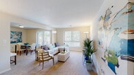 Located at 3205 Hewitt Ave in Silver Spring, Maryland, this single-floor residence offers a well-organized layout designed for comfortable everyday living. The interior is finished with neutral tones, plush wall-to-wall carpeting in the living and sleeping areas, and consistent white walls that contribute to a clean, airy atmosphere throughout.

The living room is notably spacious, featuring multiple windows fitted with horizontal blinds and vertical panel blinds that frame lush outdoor greenery. A sliding glass door leads to a balcony, further enhancing the connection to the outdoors. The dining area sits adjacent to the living space, providing a natural flow for entertaining. The kitchen features wood-look flooring, white cabinetry, and stainless steel appliances including a gas range, dishwasher, and refrigerator.

The bedrooms are generously proportioned, each with large windows that invite natural light and views of surrounding foliage. Closet space is well-represented throughout. Two bathrooms serve the unit, each with a tub-shower combination. One bathroom includes a separate vanity area with a wide mirror and built-in cabinetry, adding functionality and convenience to the private quarters.