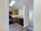 This 700 square foot apartment in Fayetteville, NC offers a thoughtful blend of comfort and functionality. The single-story layout comprises one bedroom, one bathroom, and an open-concept kitchen and living area. The kitchen stands out with its rich, dark wood cabinetry, granite countertops, and stainless steel appliances, including a refrigerator, stove, and over-the-range microwave. The living space is brightened by large windows and illuminated by a modern ceiling fan with light fixtures.

The bedroom, measuring 170 square feet, features plush carpeting, a ceiling fan, and ample natural light from a sizable window. The bathroom boasts a full-sized tub-shower combination with a sleek design. Throughout the apartment, neutral-toned walls and carpeting create a versatile canvas for personalization. The hallway provides easy access to all rooms, enhancing the apartment's flow. Notable features include wood-look flooring in the kitchen area, multiple electrical outlets for convenience, and window blinds for privacy. This well-designed space efficiently utilizes every square foot, offering a comfortable and modern living experience.