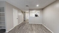 This well-appointed two-story home offers 2 bedrooms and 3 bathrooms across two thoughtfully laid-out floors. The main level features an open living room with durable wood-look vinyl plank flooring, a textured ceiling, and a classic fireplace flanked by built-in shelving — ideal for display or storage. A pass-through window connects the living area to the kitchen, which is outfitted with gray shaker-style cabinetry, white quartz countertops, stainless steel appliances including a range and dishwasher, and a matte black faucet. A dedicated laundry area and a convenient half bathroom with a round mirror and matte black fixtures round out the lower level. Upstairs, the two bedrooms are finished with plush carpet and neutral tones. The primary bedroom offers a ceiling fan, a bright window with natural light, and dual closets. The additional bedroom also features dual closets for ample storage. The upper-level bathrooms continue the modern aesthetic with gray vanity cabinetry, quartz countertops, undermount sinks, and matte black hardware. Throughout the home, a cohesive neutral color palette and contemporary fixtures create a clean, move-in-ready feel.