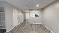 This well-appointed two-story home offers 2 bedrooms and 3 bathrooms across two thoughtfully laid-out floors. The main level features an open living room with durable wood-look vinyl plank flooring, a textured ceiling, and a classic fireplace flanked by built-in shelving — ideal for display or storage. A pass-through window connects the living area to the kitchen, which is outfitted with gray shaker-style cabinetry, white quartz countertops, stainless steel appliances including a range and dishwasher, and a matte black faucet. A dedicated laundry area and a convenient half bathroom with a round mirror and matte black fixtures round out the lower level. Upstairs, the two bedrooms are finished with plush carpet and neutral tones. The primary bedroom offers a ceiling fan, a bright window with natural light, and dual closets. The additional bedroom also features dual closets for ample storage. The upper-level bathrooms continue the modern aesthetic with gray vanity cabinetry, quartz countertops, undermount sinks, and matte black hardware. Throughout the home, a cohesive neutral color palette and contemporary fixtures create a clean, move-in-ready feel.