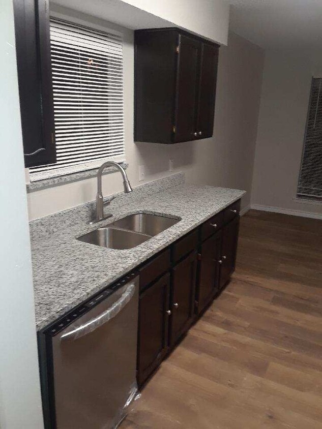 Kitchen- new granite, dish washer, floors, paint, baseboards, and updated cabinets with new hardware. - 2801 Woodmont tr