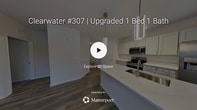 This contemporary 1-bedroom, 1-bathroom apartment in Jacksonville, FL offers 770 square feet of thoughtfully designed living space. The open-concept floor plan seamlessly integrates the kitchen, living, and dining areas, creating a spacious feel. The kitchen boasts white cabinetry, quartz countertops, and stainless steel appliances, including a sleek range and over-the-range microwave. 

The living area features attractive wood-look flooring and is illuminated by large windows that flood the space with natural light. A modern ceiling fan adds both style and functionality. The bedroom, measuring 230 square feet, provides ample space and includes plush carpeting for comfort. 

The bathroom is well-appointed with a double vanity, ample storage, and a shower/tub combination. Throughout the apartment, neutral tones create a calm and inviting atmosphere. Additional features include in-unit laundry facilities and closet space for storage. This single-story residence combines modern amenities with practical design, offering a comfortable and stylish living environment.