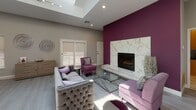 Located at 1700 N Dupont Highway in Dover, Delaware, this thoughtfully designed single-floor commercial space combines modern aesthetics with functional versatility. The centerpiece of the space is a striking lounge area defined by soaring vaulted ceilings bathed in natural light from multiple large skylights overhead. A bold magenta accent wall frames an elegant floor-to-ceiling marble fireplace surround, creating a dramatic focal point complemented by plush tufted seating, purple accent chairs, and a geometric glass coffee table. Light hardwood-style flooring runs throughout, enhancing the bright, airy atmosphere. Large sliding glass doors and windows along the perimeter invite abundant natural light and provide views of the surrounding exterior. Adjacent to the lounge, a dedicated office area features multiple workstations with modern desks and purple accent chairs, offering a professional and well-lit environment for staff. A compact kitchenette is also present, equipped with warm maple cabinetry, dark granite countertops, a stainless steel refrigerator, and a utility sink — providing practical amenities for daily use. The cohesive color palette of soft gray, white, and rich purple tones carries throughout the space, delivering a polished and contemporary ambiance suited for client-facing or professional use.