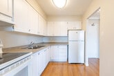 Located at 108 Edgehill Dr in Barrie, Ontario, this single-floor, three-bedroom, two-bathroom unit offers a clean and functional layout with a bright, neutral aesthetic throughout. Warm hardwood-style flooring flows seamlessly across every room, creating a cohesive and inviting atmosphere.

The combined kitchen and living area anchors the unit, with the kitchen featuring white cabinetry extending to the ceiling for ample storage, a double sink, a white electric range, and a refrigerator, all set atop matching hardwood-style floors. The open living area is bathed in natural light from a large sliding glass door, complemented by a ceiling fan overhead.

A well-lit hallway connects the three bedrooms, each finished with the same warm flooring and neutral walls. The primary bedroom offers a generous footprint with a sliding-door closet, while the additional bedrooms feature windows overlooking the surrounding treed landscape, filling the rooms with natural light. One bedroom also includes a built-in sliding-panel closet.

The two bathrooms are clean and functional, with one featuring a full soaker tub and shower surrounded by crisp white tile and chrome fixtures. Textured ceilings are present throughout, adding a classic finish to the space. The overall ambiance is bright, well-maintained, and move-in ready.