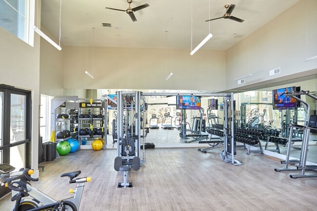 Well Equipped Fitness Room with Free Weights, Conditioning Equipment, Treadmills, Yoga Mats - Addison Medical Center Apartments