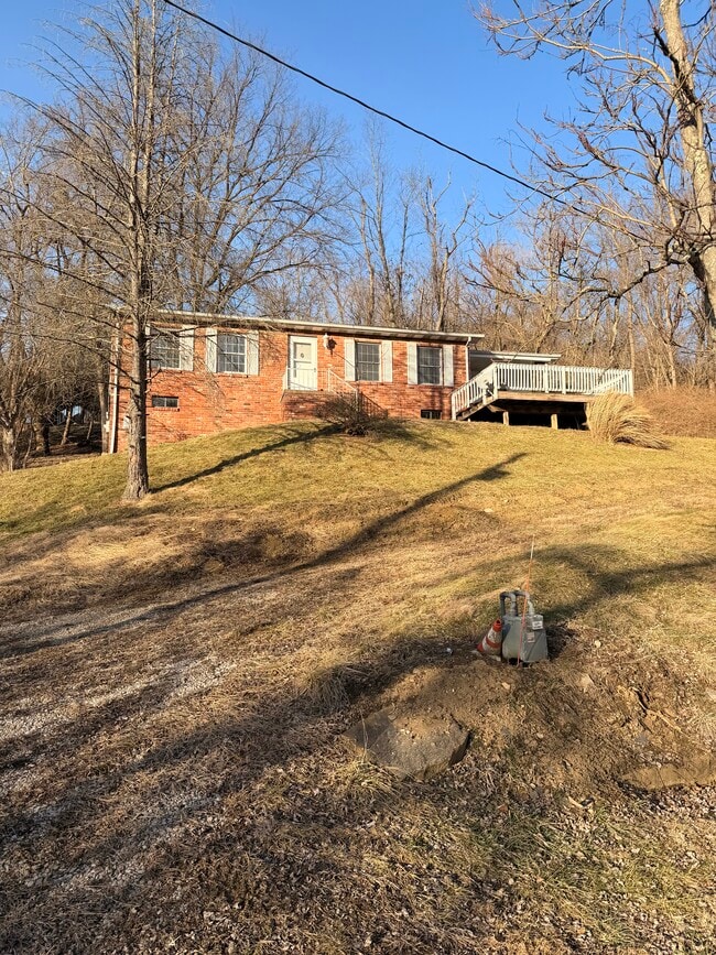 Outside of the house, it’s located on a hill. - 1 Sylvan Spring Dr