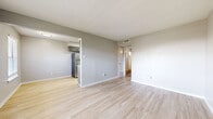 Located at 605 N Alexander Ave in Duncanville, TX, this efficient one-bedroom, one-bathroom residence is thoughtfully laid out across a single floor. Light wood-style flooring flows throughout the main living areas, complemented by neutral gray walls that create a clean, modern aesthetic.

The open living room offers a bright and airy atmosphere, with a window allowing natural light to filter in. It connects seamlessly to the combined dining and kitchen area, where gray cabinetry, white subway tile backsplash, and stainless steel appliances — including a full-size refrigerator, microwave, and range — make for a well-appointed cooking space with light wood-style flooring continuing underfoot.

The bedroom is carpeted for comfort, featuring a ceiling fan with overhead lighting, a window with blinds for natural light and privacy, and a spacious closet with ample storage. The unit also includes multiple additional closets, providing generous storage throughout.

The bathroom is finished with a gray vanity cabinet topped with a white countertop, a framed mirror, and brushed nickel fixtures, lending a polished, contemporary feel. Clean lines and neutral tones throughout the unit create a cohesive and inviting living environment.