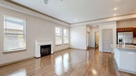 Located at 2151 Prairie Drive in Prosper, TX, this 2-bedroom, 2-bathroom single-floor residence offers a thoughtfully designed open-concept layout. The combined living, dining, and kitchen area forms the heart of the home, anchored by gleaming hardwood-style flooring that flows throughout the main spaces. The living room features a classic white-mantled fireplace, ceiling fan, and multiple windows dressed with blinds that invite ample natural light. Tray ceilings with crown molding add an architectural touch throughout.

The kitchen is well-equipped with rich dark-toned cabinetry, granite countertops, a center island with a sink, and a full suite of stainless steel appliances including a refrigerator, range, microwave, and dishwasher. A dedicated pantry provides additional storage.

The generously sized primary bedroom includes plush carpeting, a tray ceiling, and an en-suite bathroom with a glass-enclosed walk-in shower. A walk-in closet with dual hanging rods offers ample storage. The second bedroom also features carpet flooring and a natural light-filled window. Additional conveniences include a dedicated laundry room, hallway, and two well-appointed closets, rounding out this functional and comfortable residence.