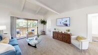Located at 4 Austin in Irvine, CA, this well-designed 2-bedroom, 2-bathroom single-story home offers a thoughtful layout across one floor. The living room immediately impresses with its vaulted, exposed-beam ceiling, lending an open and airy feel to the space. Plush carpeting, a sliding glass door, and a private balcony with lush outdoor views make this room a welcoming retreat. The kitchen is outfitted with white cabinetry, granite-style countertops, wood-look flooring, and a double-basin sink, with natural light streaming in through a large window overlooking the exterior. A dining nook adjacent to the kitchen adds functional versatility. The primary bedroom is generously sized, featuring a ceiling fan, carpeted floors, a wide window with outdoor views, and ample closet space. The second bedroom is equally comfortable, with natural light and a sliding mirrored closet. Both bathrooms are finished with granite-topped vanities, wood-look flooring, and tub-shower combinations, offering clean and functional design. A connecting hallway ties the layout together efficiently. Throughout the home, a bright, neutral palette and abundant natural light create a calm, comfortable atmosphere well-suited to Irvine's sunny Southern California setting.
