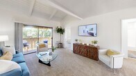Located at 4 Austin in Irvine, CA, this well-designed 2-bedroom, 2-bathroom single-story home offers a thoughtful layout across one floor. The living room immediately impresses with its vaulted, exposed-beam ceiling, lending an open and airy feel to the space. Plush carpeting, a sliding glass door, and a private balcony with lush outdoor views make this room a welcoming retreat. The kitchen is outfitted with white cabinetry, granite-style countertops, wood-look flooring, and a double-basin sink, with natural light streaming in through a large window overlooking the exterior. A dining nook adjacent to the kitchen adds functional versatility. The primary bedroom is generously sized, featuring a ceiling fan, carpeted floors, a wide window with outdoor views, and ample closet space. The second bedroom is equally comfortable, with natural light and a sliding mirrored closet. Both bathrooms are finished with granite-topped vanities, wood-look flooring, and tub-shower combinations, offering clean and functional design. A connecting hallway ties the layout together efficiently. Throughout the home, a bright, neutral palette and abundant natural light create a calm, comfortable atmosphere well-suited to Irvine's sunny Southern California setting.