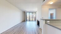 Located at 1221 N Orange Dr in the heart of Hollywood, Los Angeles, this 1-bedroom, 1-bathroom unit offers a well-designed single-floor layout. The open living room is bright and airy, featuring light wood-style flooring, crisp white walls, and a classic fireplace as a focal point. A large grid-pane sliding glass door fills the space with natural light and opens to a private balcony overlooking the neighborhood, with sweeping views of iconic palm trees and the surrounding Los Angeles streetscape under clear blue skies. The galley-style kitchen is efficiently arranged with white cabinetry, dark countertops, stainless steel appliances including a gas range, microwave, refrigerator, and dishwasher, all complemented by light wood flooring. The generously sized bedroom features soft carpeting, a grid-pane window with lush outdoor views, and direct access to a dedicated walk-in closet. The bathroom is clean and functional, finished with light wood flooring, a tub-shower combination with a sliding glass enclosure, and white paneled wainscoting. The overall ambiance is clean, modern, and move-in ready, offering comfortable urban living in one of LA's most vibrant neighborhoods.