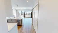 This contemporary 920 square foot apartment offers a harmonious blend of style and functionality. The open-concept living area is adorned with sleek hardwood flooring, creating a seamless flow between the living room, dining area, and kitchen. Floor-to-ceiling windows flood the space with natural light and provide stunning city views.

The gourmet kitchen is a culinary enthusiast's dream, featuring high-end stainless steel appliances, ample white cabinetry, and a large center island with a stylish blue base. Quartz countertops and a subway tile backsplash complete the modern aesthetic.

Two well-appointed bedrooms offer comfort and privacy. The primary bedroom, spanning 170 square feet, boasts large windows and ample closet space. Both bathrooms showcase luxurious finishes, with one featuring a walk-in shower with elegant marble-look tiling and the other a sleek white bathtub-shower combination.

A spacious balcony extends the living space outdoors, perfect for al fresco dining or relaxation while enjoying the urban panorama. Throughout the apartment, recessed lighting and modern fixtures enhance the contemporary ambiance. With its thoughtful design and high-quality finishes, this apartment offers a sophisticated urban living experience.