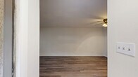 Located on Curlew Ct in Rock Hill, SC, this single-floor unit offers a thoughtfully designed layout comprising a living room, kitchen, bathroom, and closet. The living room is bright and open, featuring warm hardwood-style flooring, crisp white walls, and a ceiling fan with a light fixture that provides both comfort and illumination. Natural light filters in through double windows dressed with white blinds, offering views of surrounding greenery. The kitchen is efficiently laid out in a galley style, showcasing gray shaker-style cabinetry, granite countertops, stainless steel appliances including a refrigerator, electric range, and dishwasher, and light tile flooring that contrasts cleanly with the rest of the unit. The bathroom continues the cohesive design aesthetic with matching gray cabinetry, a granite vanity top, a tiled tub-shower combination, and elegant patterned tile flooring. A dedicated closet provides convenient storage. Throughout the unit, neutral tones, consistent finishes, and functional design choices create a clean, move-in-ready living environment suited for those seeking a comfortable and low-maintenance space in Rock Hill, SC.