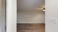 Located on Curlew Ct in Rock Hill, SC, this single-floor unit offers a thoughtfully designed layout comprising a living room, kitchen, bathroom, and closet. The living room is bright and open, featuring warm hardwood-style flooring, crisp white walls, and a ceiling fan with a light fixture that provides both comfort and illumination. Natural light filters in through double windows dressed with white blinds, offering views of surrounding greenery. The kitchen is efficiently laid out in a galley style, showcasing gray shaker-style cabinetry, granite countertops, stainless steel appliances including a refrigerator, electric range, and dishwasher, and light tile flooring that contrasts cleanly with the rest of the unit. The bathroom continues the cohesive design aesthetic with matching gray cabinetry, a granite vanity top, a tiled tub-shower combination, and elegant patterned tile flooring. A dedicated closet provides convenient storage. Throughout the unit, neutral tones, consistent finishes, and functional design choices create a clean, move-in-ready living environment suited for those seeking a comfortable and low-maintenance space in Rock Hill, SC.