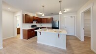 Located at 127 Madison St in Elyria, Ohio, this single-floor, 2-bedroom, 1-bathroom home offers a functional and thoughtfully designed layout. The kitchen is a standout feature, showcasing rich dark cherry cabinetry, white countertops, black appliances including a range and refrigerator, and a central island with pendant lighting and bar seating — ideal for both cooking and casual dining. Light wood-style flooring runs throughout the kitchen and main living areas, lending a clean, cohesive aesthetic.

Both bedrooms are carpeted and filled with natural light from windows overlooking the outdoors. The primary bedroom includes a dedicated walk-in closet with built-in shelving, while a secondary closet provides additional storage. The full bathroom features a shower-tub combo, modern fixtures, safety grab bars, and light wood-style flooring. A dedicated laundry room houses a full-size washer and dryer along with an overhead wire storage shelf and a water heater. Neutral wall tones and white trim throughout the home create a bright, inviting atmosphere suitable for a variety of living arrangements.