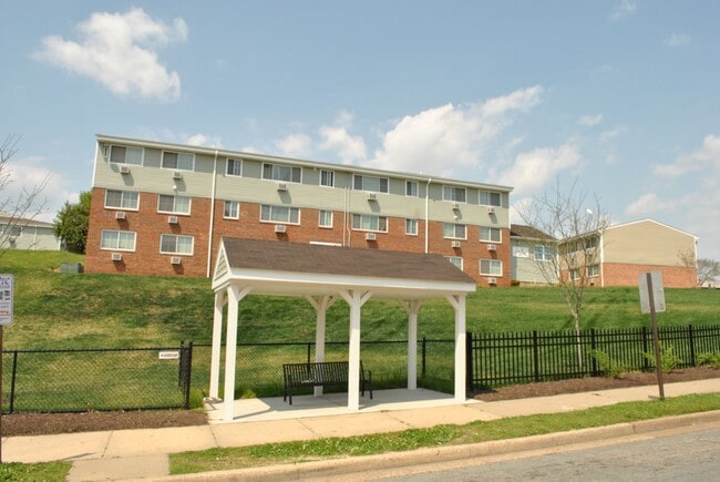 Oliver Crossing apartment community exterior with resident balconies and green space - Oliver Crossing