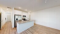 Located at 354 Arch Street in Athens, GA, this two-story home offers a clean, modern design with a thoughtful layout spread across two floors. The main level features an open-concept kitchen and living area anchored by a granite-topped island with an undermount sink, white shaker cabinetry, stainless steel appliances, and recessed lighting — all set on light luxury vinyl plank flooring that flows seamlessly throughout. A bathroom on the main level adds convenience for guests.

The upper floor houses both bedrooms, two additional bathrooms, a hallway, and two closets. The generously sized primary bedroom features a ceiling fan, natural light from a window with outdoor views, and access to a dedicated closet. The second bedroom is equally bright, with large windows that frame views of the surrounding greenery. Both bathrooms upstairs are finished with granite-topped white vanities and vinyl plank flooring, with one featuring a tub-shower combo. A staircase with warm wood treads and modern black metal balusters connects the two levels, complemented by a bright, recessed-lit hallway. The overall aesthetic is clean and contemporary, with neutral white walls and consistent finishes creating a cohesive, move-in-ready feel throughout.