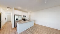 Located at 354 Arch Street in Athens, GA, this two-story home offers a clean, modern design with a thoughtful layout spread across two floors. The main level features an open-concept kitchen and living area anchored by a granite-topped island with an undermount sink, white shaker cabinetry, stainless steel appliances, and recessed lighting — all set on light luxury vinyl plank flooring that flows seamlessly throughout. A bathroom on the main level adds convenience for guests.

The upper floor houses both bedrooms, two additional bathrooms, a hallway, and two closets. The generously sized primary bedroom features a ceiling fan, natural light from a window with outdoor views, and access to a dedicated closet. The second bedroom is equally bright, with large windows that frame views of the surrounding greenery. Both bathrooms upstairs are finished with granite-topped white vanities and vinyl plank flooring, with one featuring a tub-shower combo. A staircase with warm wood treads and modern black metal balusters connects the two levels, complemented by a bright, recessed-lit hallway. The overall aesthetic is clean and contemporary, with neutral white walls and consistent finishes creating a cohesive, move-in-ready feel throughout.