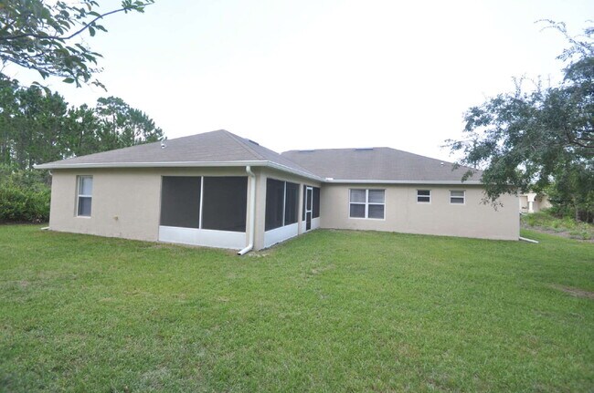 Building Photo - "Spacious 4-Bed Oasis in Palm Coast – Your...