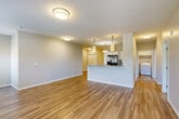Located at 19320 Pacific St in Elkhorn, Nebraska, this two-story, 3-bedroom, 3-bathroom home offers a well-designed layout across two floors. The main level centers around a bright, open-concept living room and kitchen combination finished with warm hardwood-style flooring. The kitchen is outfitted with sleek white cabinetry, a subway tile backsplash, stainless steel appliances including a French door refrigerator and electric range, and a peninsula with stylish pendant lighting overhead. The spacious living area benefits from flush-mount lighting and a neutral color palette throughout. A dedicated laundry area with washer and dryer hookups sits conveniently on the main level behind louvered doors. The three bedrooms are carpeted and each features a ceiling fan and closet space; select rooms offer natural light through windows with neighborhood views. The three bathrooms are finished with large-format tile flooring, white vanities, and quartz-style countertops. The attached garage provides additional storage and utility space with a concrete floor and automatic opener. This home combines functional living spaces with clean, contemporary finishes in a residential Elkhorn setting.