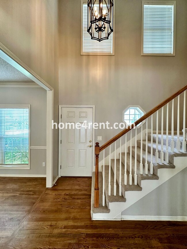 Building Photo - Beautiful Four-Bedroom Home with Three Car Garage, Wood Floors, Finished Basement and a Fenced Ya...