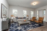 Located at 2891 Lewis St NW in Kennesaw, Georgia, this single-floor residence offers a thoughtfully designed layout with modern finishes throughout. The open-concept kitchen is a standout feature, equipped with stainless steel appliances including a range, microwave, and refrigerator, complemented by granite countertops, white shaker cabinetry, a subway tile backsplash, and rich hardwood-style flooring. A peninsula with pendant lighting and bar seating creates a natural connection to the living and dining areas, making it ideal for entertaining.

The living room is bright and welcoming, featuring large windows that invite natural light and views of the surrounding neighborhood. Hardwood-style flooring continues throughout the main living areas, adding warmth and cohesion to the space.

The bedrooms are carpeted for comfort, each benefiting from natural light through well-positioned windows. One additional flexible room provides versatile space suitable for a home office or guest room. The bathrooms are finished with granite-topped vanities, white cabinetry, and hardwood-style flooring. The primary bathroom includes a glass-enclosed shower, while the secondary bathroom offers a full tub-shower combination. The overall aesthetic is clean, neutral, and move-in ready.