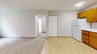 Located at 828 N Hazel St in Saint Paul, MN, this two-bedroom, one-bathroom unit offers a functional and efficient single-floor layout. The kitchen features warm oak cabinetry with ample upper and lower storage, marble-patterned countertops, a double-basin sink, and a white electric range, all set on easy-to-maintain tile flooring. Adjacent to the kitchen, the living area transitions to plush carpeting and includes a closet for additional storage, with a white refrigerator completing the space. A hallway connects the main living areas to the bedrooms and bathroom, providing a clear and organized flow throughout. The primary bedroom is a comfortable size, featuring a mirrored sliding-door closet, a ceiling fan, and a window that lets in natural light. The second bedroom is similarly carpeted with its own window and baseboard heating, creating a cozy atmosphere. Both rooms benefit from ceiling fans for year-round comfort. The bathroom is clean and straightforward, offering a full soaking tub with a shower, white tile surround, and a window for natural ventilation. Baseboard heating is present throughout the unit, ensuring warmth during Minnesota winters.