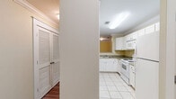 Located at 833 Old Greenville Hwy in Clemson, South Carolina, this single-floor, three-bedroom, four-bathroom unit offers a thoughtfully arranged layout with a warm and functional design throughout. The living room serves as the heart of the home, featuring hardwood-style flooring, crown molding, a ceiling fan, and a window that invites natural light, creating a bright and welcoming atmosphere. An arched pass-through connects the living area to the kitchen, which is outfitted with white cabinetry, tile flooring, a full suite of white appliances including a range, microwave, refrigerator, and dishwasher, as well as ample counter and storage space. Each of the three bedrooms continues the hardwood-style flooring and ceiling fan motif, with some rooms featuring built-in shelving units that offer additional storage and display space. The primary bedroom provides a comfortable, generously sized retreat. The four bathrooms are finished with tile flooring, white vanities with under-sink storage, well-lit mirrors, and tub-shower combinations with clean white tile surrounds. Two closets provide convenient additional storage. The overall palette of soft warm yellows and crisp whites gives the space a clean, cohesive, and inviting character throughout.