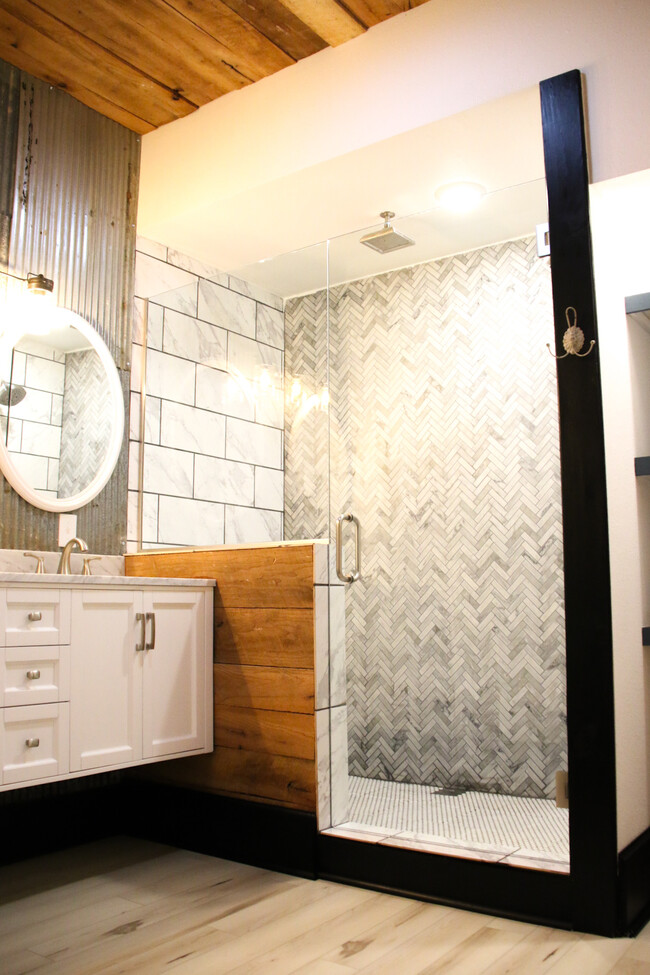 Custom marble shower with overhead rain shower head. - 725 S Baker St