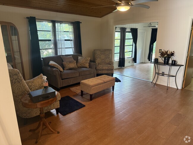 The spacious living room opens into a bright bonus room. - 6425 5th St