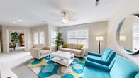 This thoughtfully designed single-floor residence offers a complete and functional layout comprising a living room, bedroom, office, kitchen, bathroom, hallway, and utility room. The bright and airy living room is a standout space, featuring a ceiling fan, neutral toned walls, soft carpeted flooring, and multiple windows fitted with blinds that allow ample natural light to fill the room. The kitchen is equipped with warm wood cabinetry, stainless steel appliances including a range and built-in microwave, a mosaic tile backsplash, and hardwood flooring, offering both style and practicality. The hallway connects the spaces seamlessly and features elegant crown molding, chair rail detailing, and views into the adjoining kitchen and office areas. The dedicated office space provides an ideal work-from-home setup. The bedroom is a comfortable and inviting retreat, complete with plush carpeting, a ceiling fan, a natural light-admitting window, and a closet with classic paneled doors. The bathroom features hardwood flooring, warm wood vanity cabinetry with a stone-topped countertop, and a shower-tub combination. A utility room completes the layout, adding essential convenience to this well-rounded residence.
