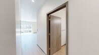 Located at 4415 East Longfellow Avenue in Spokane, WA, this well-appointed one-bedroom, one-bathroom unit offers a thoughtfully designed open-concept layout with clean, modern finishes throughout. Light-toned luxury vinyl plank flooring runs continuously through every room, creating a cohesive and airy feel.

The kitchen is a standout feature, boasting crisp white shaker cabinetry extending to the ceiling, white quartz countertops, a classic subway tile backsplash, and a full suite of stainless steel appliances including a refrigerator, range, microwave, and dishwasher. A central kitchen island with pendant lighting above provides additional prep space and anchors the open living area.

The living room is bright and spacious, filled with natural light through large sliding glass doors that open onto a private balcony. The balcony offers open views of the surrounding community and a backdrop of Pacific Northwest pine trees — ideal for relaxing outdoors.

The bedroom is a generous, well-proportioned room accessed through the hallway, which also features additional storage. The bathroom is clean and contemporary, with white shaker vanity cabinetry, quartz countertop, a framed mirror, and light wood-toned flooring that mirrors the rest of the unit. The overall ambiance is bright, neutral, and move-in ready.