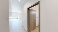 Located at 4415 East Longfellow Avenue in Spokane, WA, this well-appointed one-bedroom, one-bathroom unit offers a thoughtfully designed open-concept layout with clean, modern finishes throughout. Light-toned luxury vinyl plank flooring runs continuously through every room, creating a cohesive and airy feel.

The kitchen is a standout feature, boasting crisp white shaker cabinetry extending to the ceiling, white quartz countertops, a classic subway tile backsplash, and a full suite of stainless steel appliances including a refrigerator, range, microwave, and dishwasher. A central kitchen island with pendant lighting above provides additional prep space and anchors the open living area.

The living room is bright and spacious, filled with natural light through large sliding glass doors that open onto a private balcony. The balcony offers open views of the surrounding community and a backdrop of Pacific Northwest pine trees — ideal for relaxing outdoors.

The bedroom is a generous, well-proportioned room accessed through the hallway, which also features additional storage. The bathroom is clean and contemporary, with white shaker vanity cabinetry, quartz countertop, a framed mirror, and light wood-toned flooring that mirrors the rest of the unit. The overall ambiance is bright, neutral, and move-in ready.