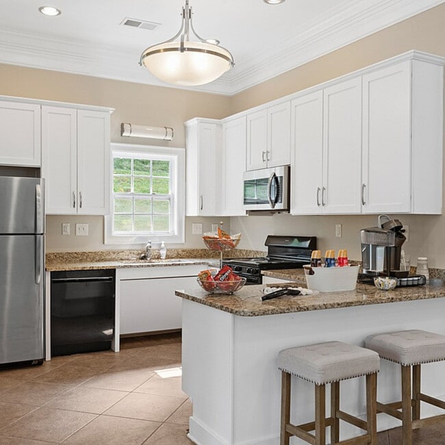 Experience the elegance of this contemporary kitchen, complete with stylish finishes and inviting features. - West Pointe