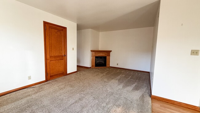 Living Room with electric fireplace - Brentwood Apartments