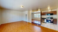 Located at 2500 Dana St in Berkeley, CA, this two-bedroom, one-bathroom unit offers a functional and comfortable single-floor layout. Warm hardwood flooring flows throughout the main living areas and bedrooms, lending a cohesive and inviting feel to the space. The open living room is generously lit by a bank of large windows that frame views of the surrounding neighborhood, filling the room with natural light. A dedicated dining area adjoins the kitchen, which is outfitted with rich dark-toned cabinetry, granite countertops, tile flooring, and a full suite of stainless steel appliances including a refrigerator, range, microwave, and dishwasher. The two bedrooms are well-proportioned, each featuring hardwood floors and natural light. One bedroom includes a low horizontal window with an outdoor view, while the other benefits from easy access to the shared spaces. The full bathroom is cleanly finished with a combination tub and shower featuring white tile surround, a dark wood vanity with ample storage, and a large mirror. Two closets provide additional storage throughout the unit. The entrance offers a welcoming transition into the main living space, completing this efficiently designed home in a prime Berkeley location.