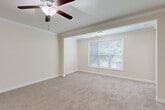 Located at 201 Regents Center Cir in Lexington, NC, this single-story home offers three bedrooms, three bathrooms, and a well-organized layout designed for comfortable everyday living. The interior is finished with warm, neutral tones throughout, creating a cohesive and inviting atmosphere.

The kitchen is outfitted with rich medium-toned wood cabinetry, granite countertops, tile flooring, and stainless steel appliances, including a range and over-the-range microwave. It connects directly to the dining area, which features crown molding, a chandelier, chair-rail detailing, and tile flooring — an elegant touch for entertaining.

The primary bedroom is a generously sized retreat complete with plush carpeting, crown molding, a ceiling fan with light fixture, and a large window that allows natural light and outdoor views to filter in. The additional bedrooms also feature carpet flooring, neutral walls, and natural light, with one room offering multiple windows for a bright, airy feel.

Each bathroom is finished with tile flooring, wood vanities with granite countertops, and tub-shower combinations with brushed nickel hardware. The dedicated laundry room includes washer and dryer hookups, a gas connection, and overhead wire shelving for added storage. Three closets provide ample storage throughout the home.
