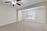 Located at 201 Regents Center Cir in Lexington, NC, this single-story home offers three bedrooms, three bathrooms, and a well-organized layout designed for comfortable everyday living. The interior is finished with warm, neutral tones throughout, creating a cohesive and inviting atmosphere.

The kitchen is outfitted with rich medium-toned wood cabinetry, granite countertops, tile flooring, and stainless steel appliances, including a range and over-the-range microwave. It connects directly to the dining area, which features crown molding, a chandelier, chair-rail detailing, and tile flooring — an elegant touch for entertaining.

The primary bedroom is a generously sized retreat complete with plush carpeting, crown molding, a ceiling fan with light fixture, and a large window that allows natural light and outdoor views to filter in. The additional bedrooms also feature carpet flooring, neutral walls, and natural light, with one room offering multiple windows for a bright, airy feel.

Each bathroom is finished with tile flooring, wood vanities with granite countertops, and tub-shower combinations with brushed nickel hardware. The dedicated laundry room includes washer and dryer hookups, a gas connection, and overhead wire shelving for added storage. Three closets provide ample storage throughout the home.